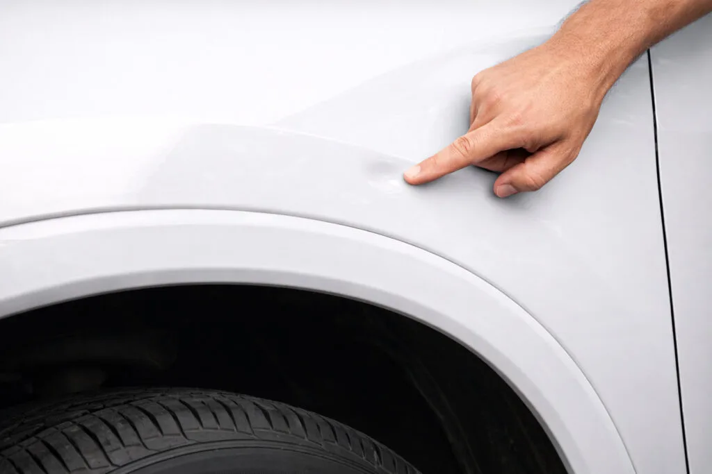 Close-up of a minor car dent before paintless dent repair by The Dent Brothers